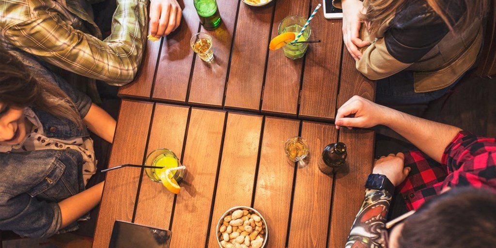 a group of people sitting around a table with drinks