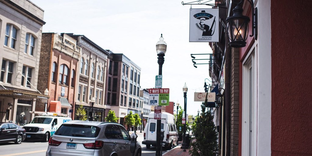 a city street with cars and buildings and street signs