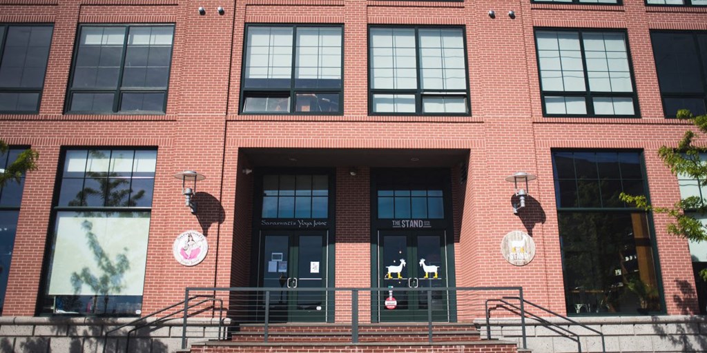 the front of a brick building with two sets of stairs