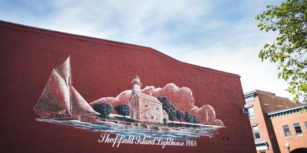a mural on the side of a red brick building