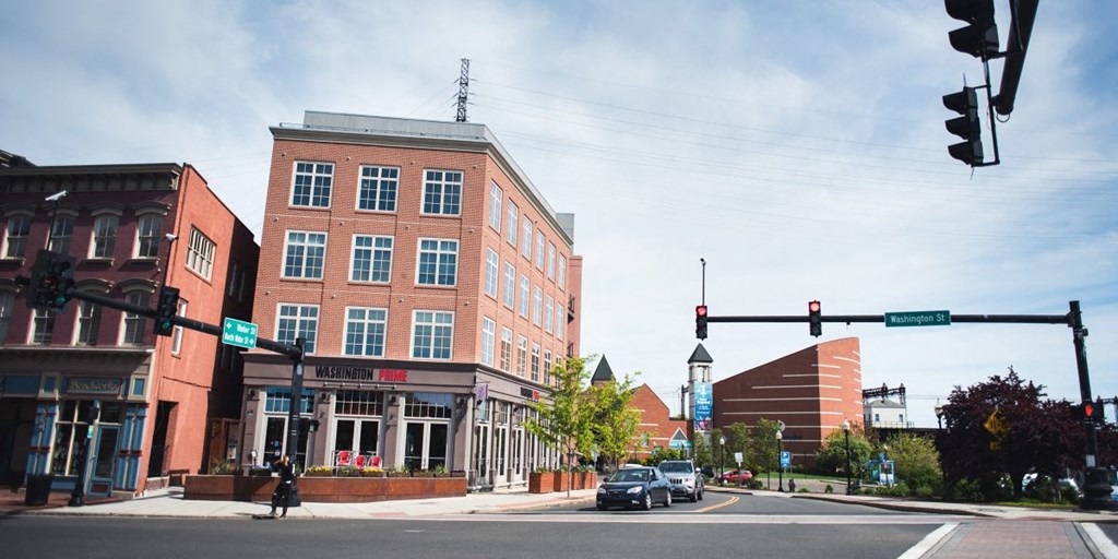 a city street with a traffic light and a brick building