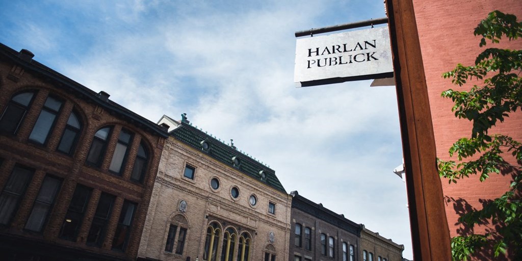 a street sign on the side of a brick building