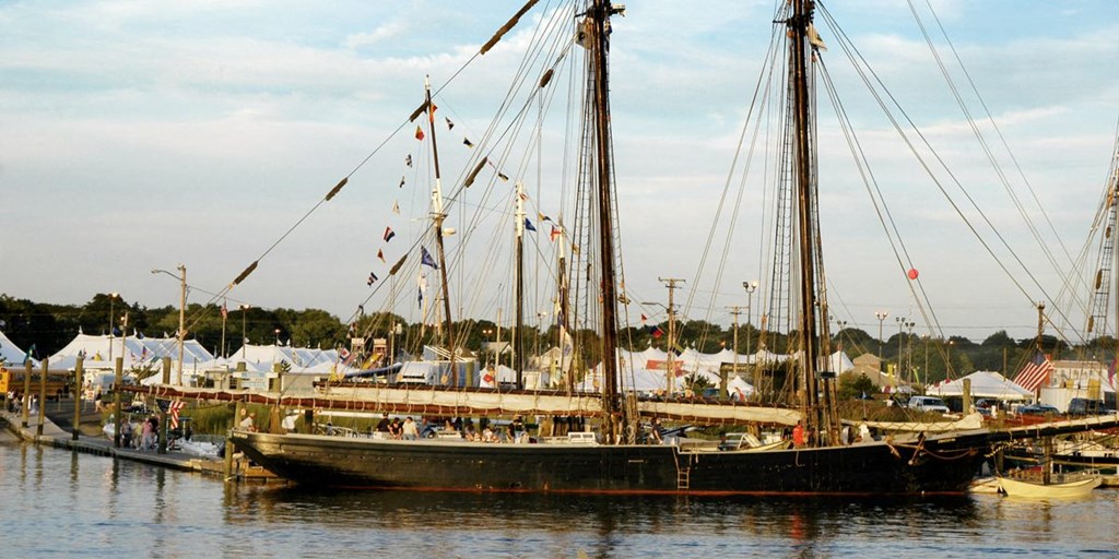 a large boat is docked in a harbor with other boats