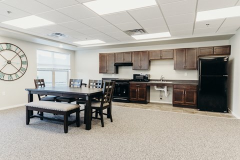 a kitchen and dining room with a table and chairs