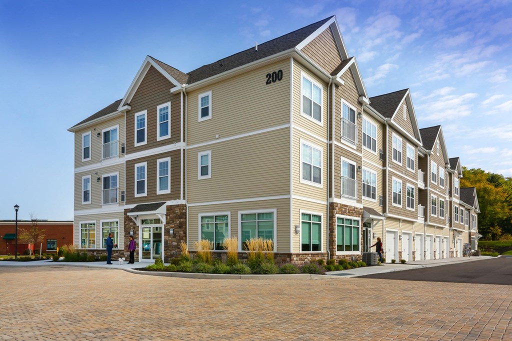 a large apartment building with a street in front of it
