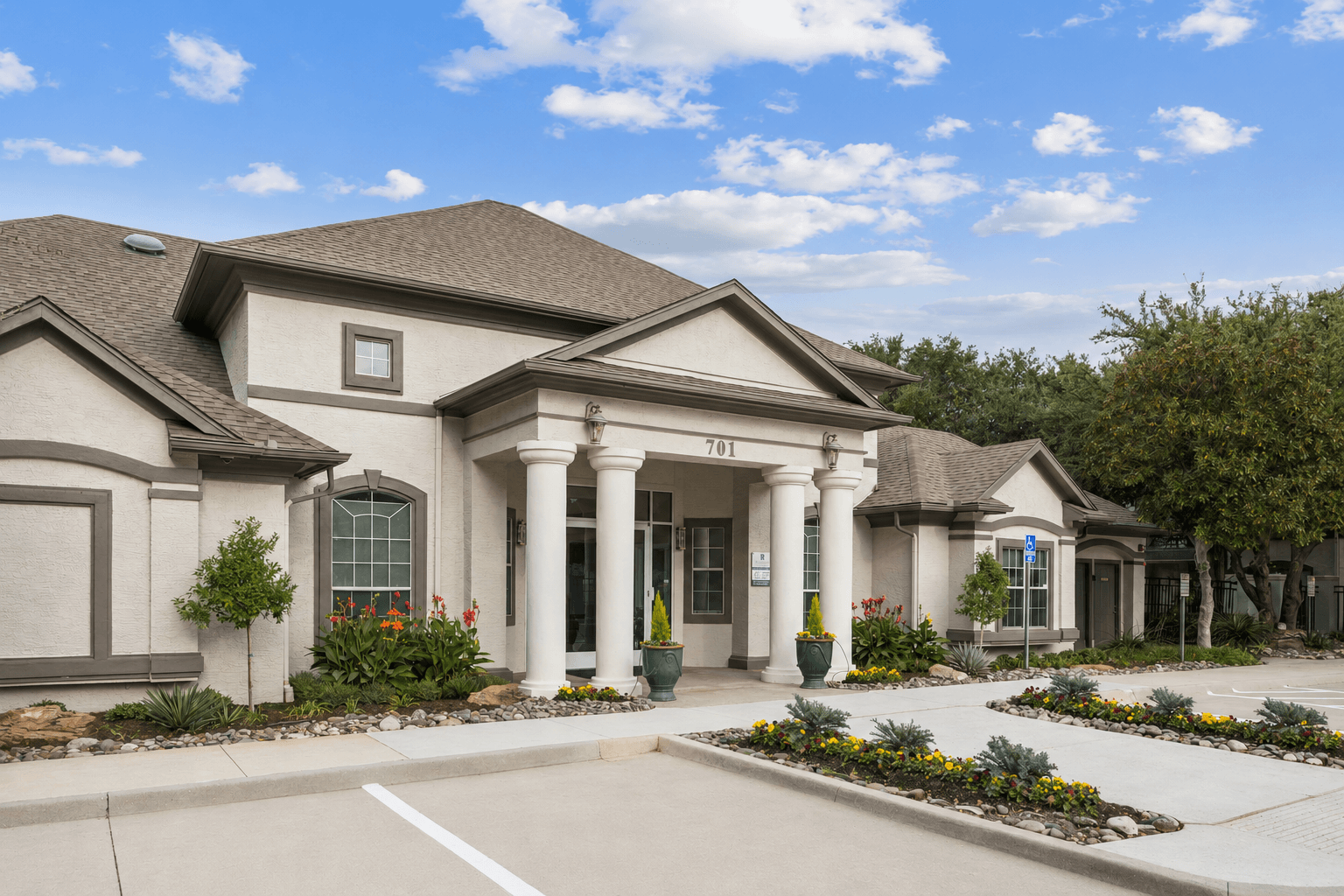 A large house with a front yard and landscaping.