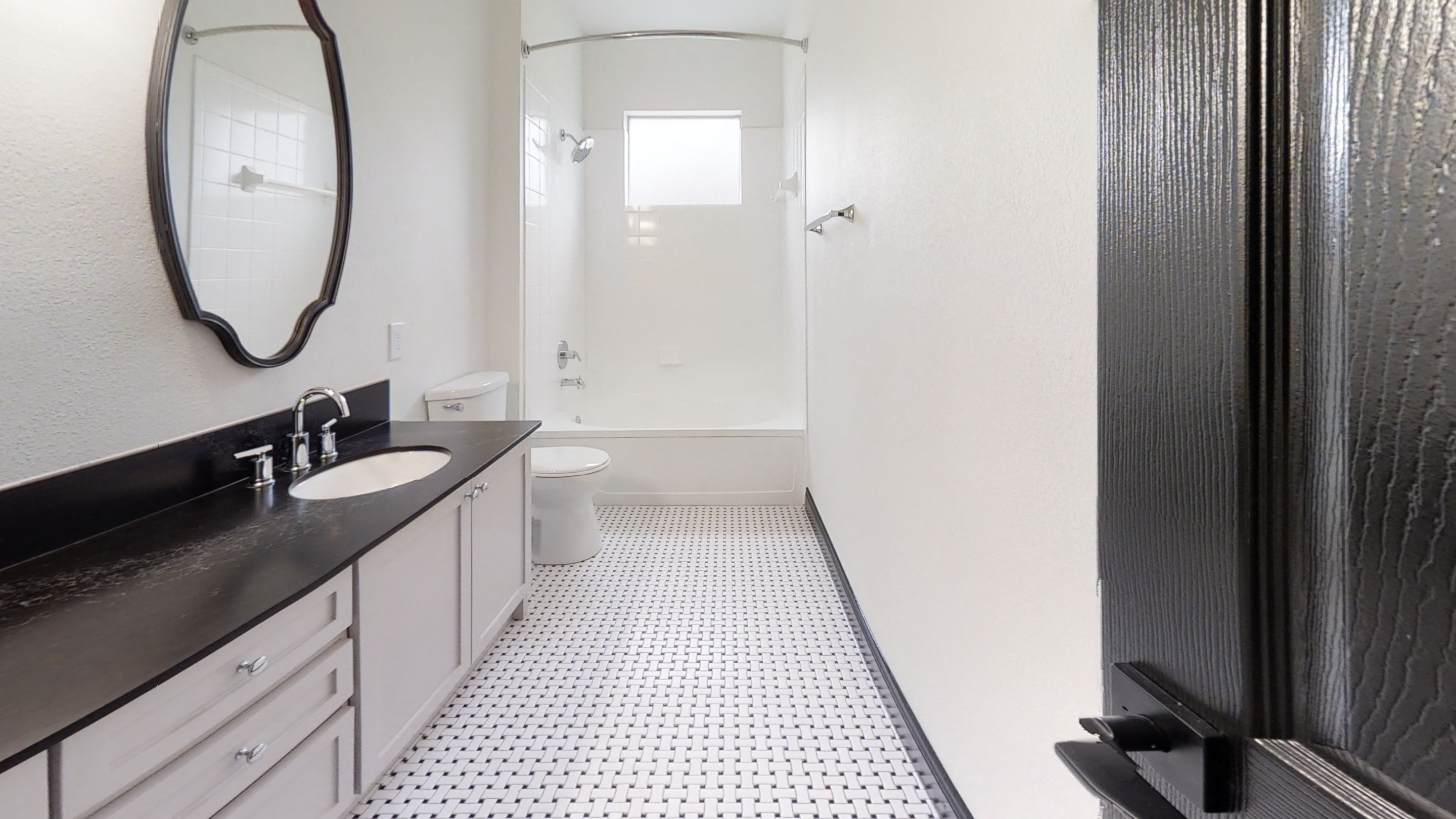 Renovated Bathrooms with Black Quartz Countertops and Tile Flooring