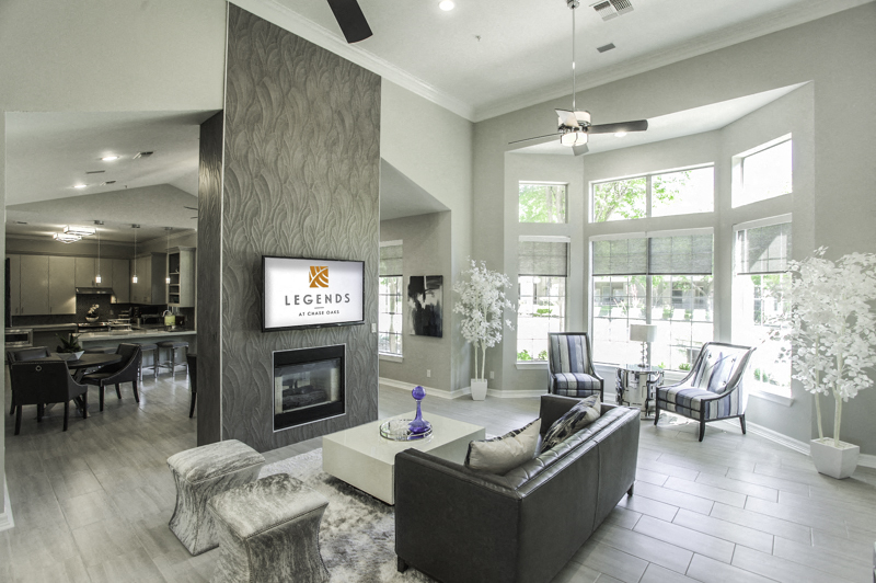 a living room with a fireplace and a tv on the wall