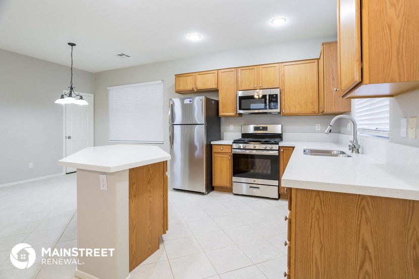 a kitchen with wooden cabinets and stainless steel appliances