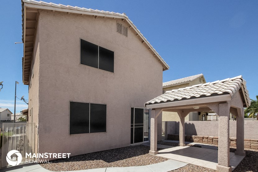 the front of the house with awning and a garage