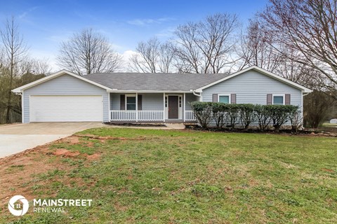 the front of a house with a yard and a porch