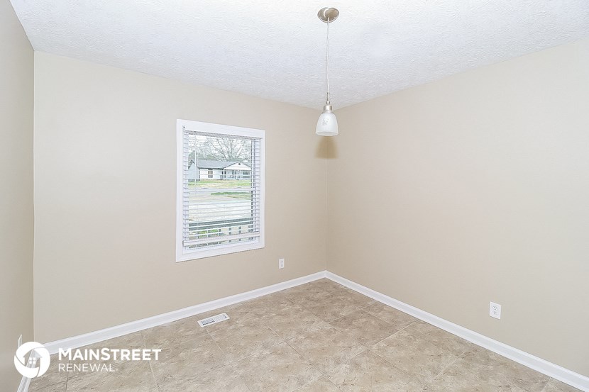 the living room of an empty house with a window