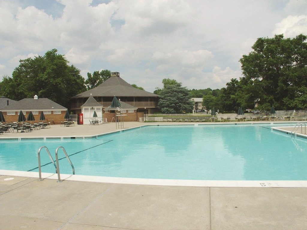 a swimming pool with a building in the background