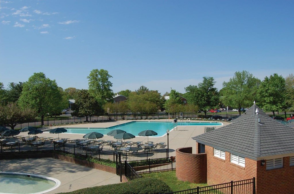 a swimming pool with umbrellas and chairs around it