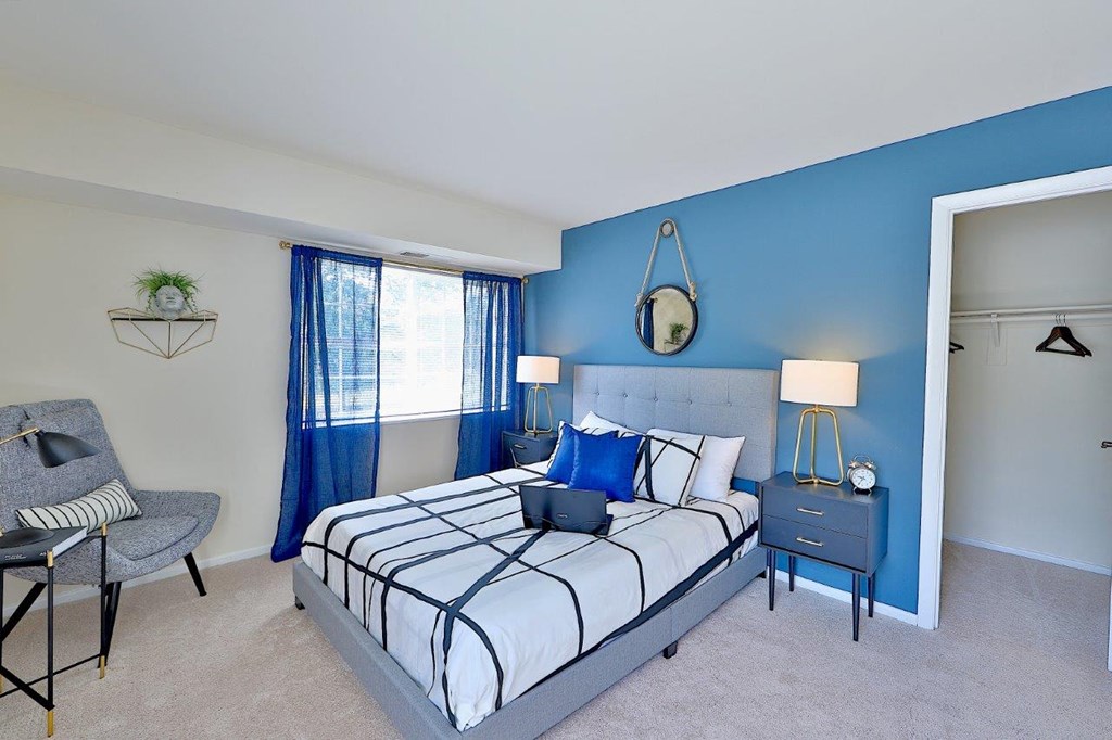 a bedroom with a bed and a blue wall