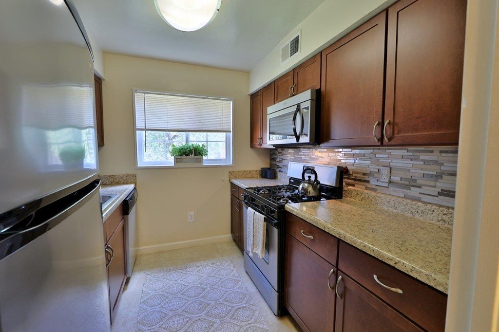 a kitchen with stainless steel appliances and granite counter tops