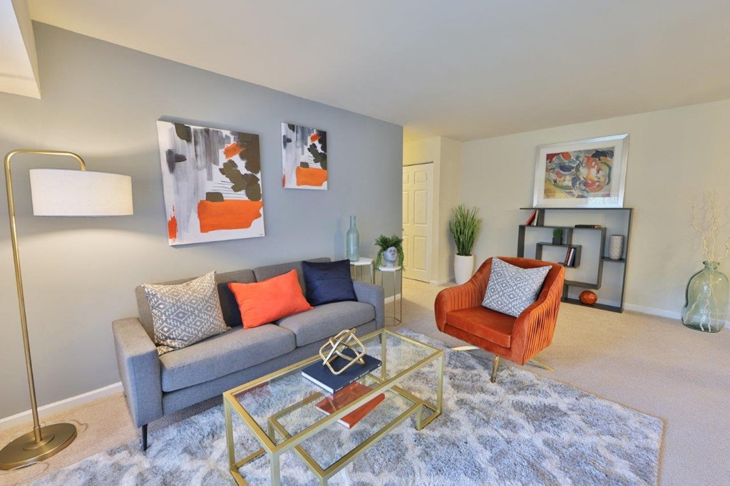 a living room with a couch and a glass table
