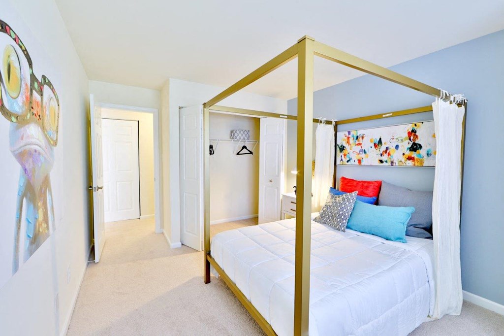 a gold canopy bed in a bedroom with blue walls
