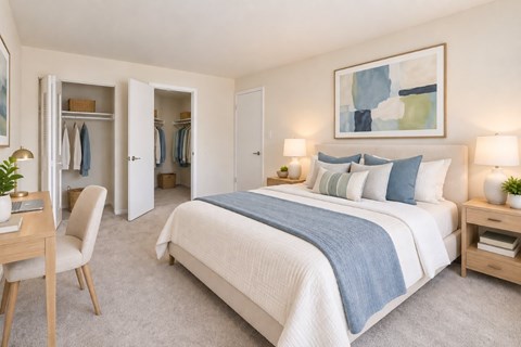 A bedroom with a large bed and a chair.