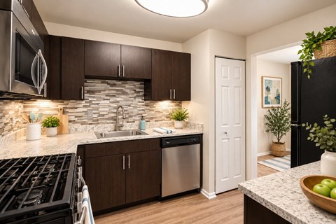 A modern kitchen with dark brown cabinets and a black stove top.