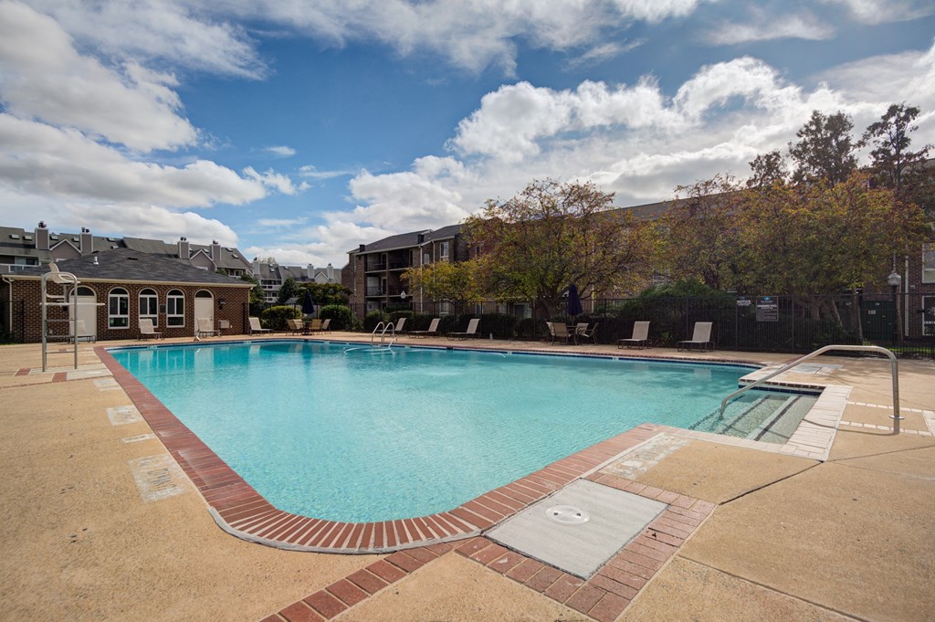 a swimming pool with a building in the background