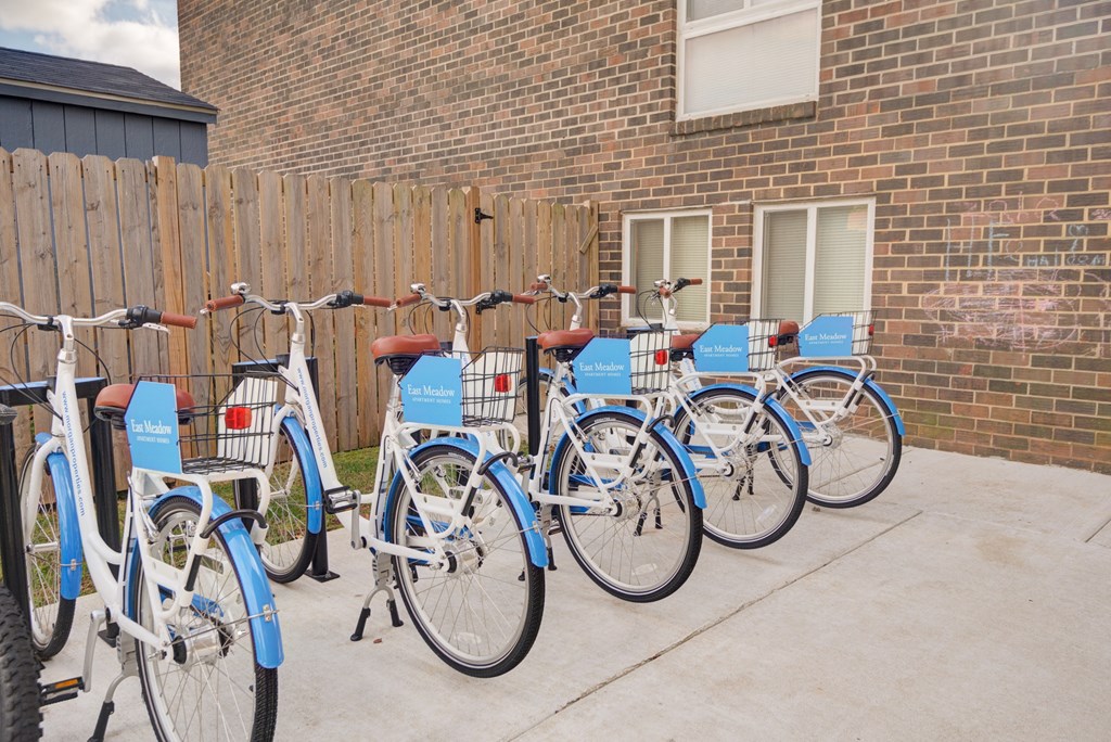a row of bikes parked in front of a brick building