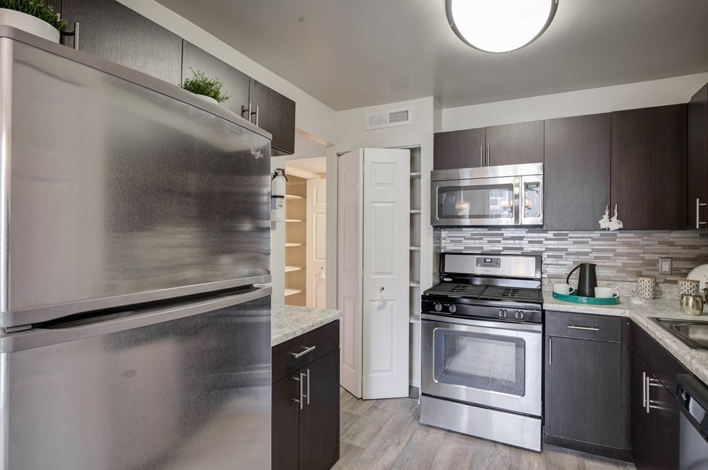 a kitchen with stainless steel appliances and a stainless steel refrigerator