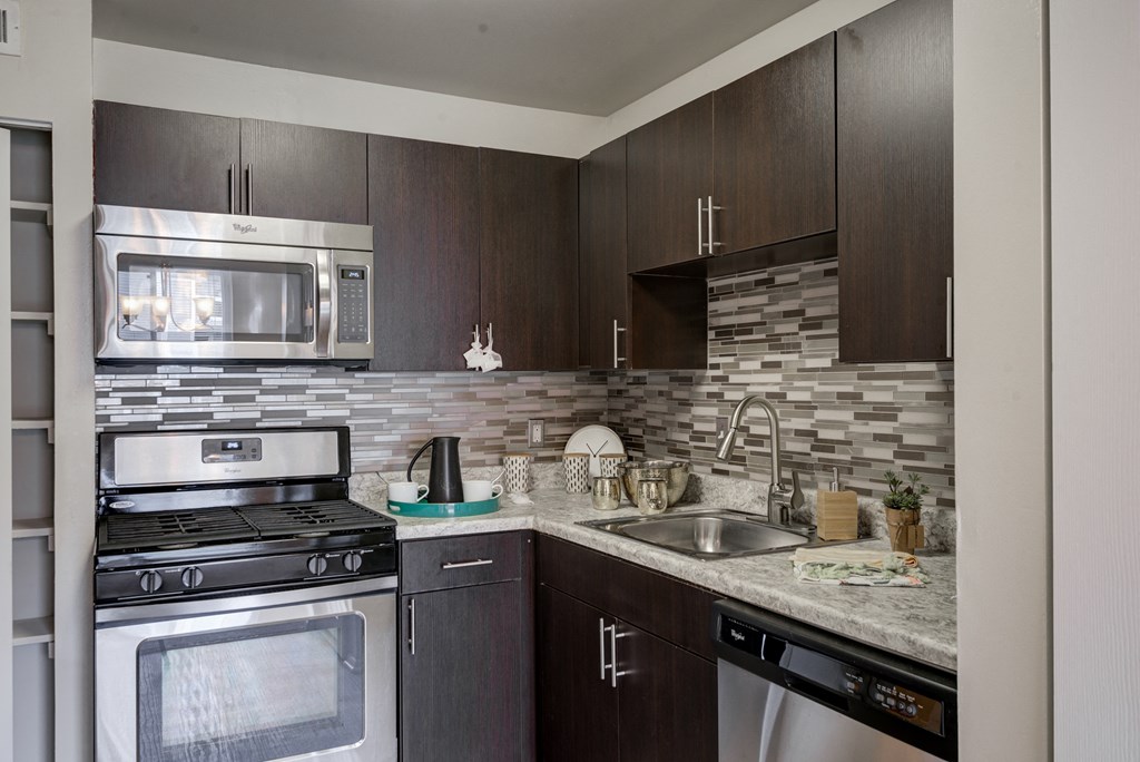a kitchen with stainless steel appliances and wooden cabinets