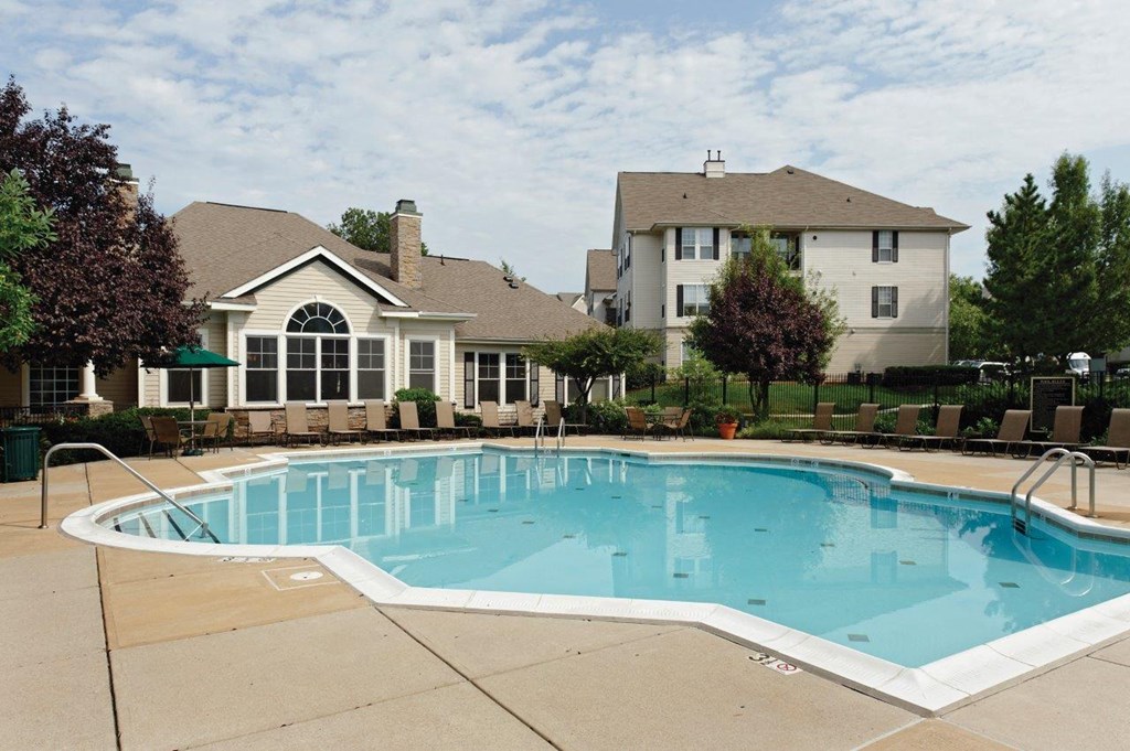 a swimming pool with a house in the background