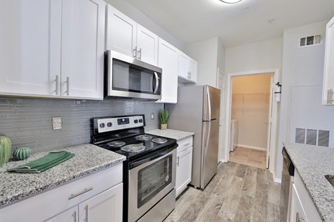 a kitchen with stainless steel appliances and white cabinets