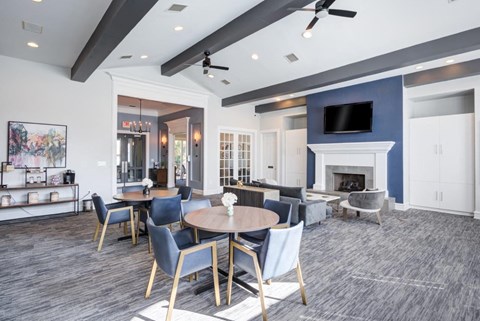 a living room with a table and chairs and a fireplace