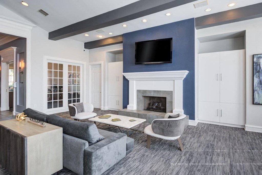 a living room with a blue accent wall and a fireplace
