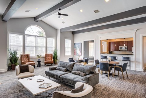 a living room with a couch and a table with chairs