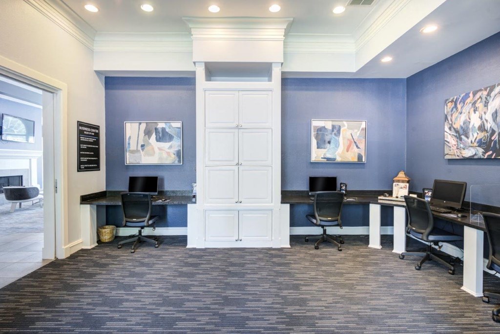 a conference room with two desks and chairs and a door