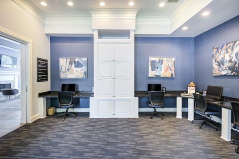 a conference room with two desks and chairs and a door
