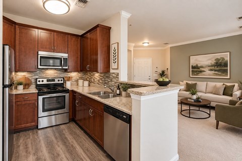 A kitchen with wooden cabinets and a white island.