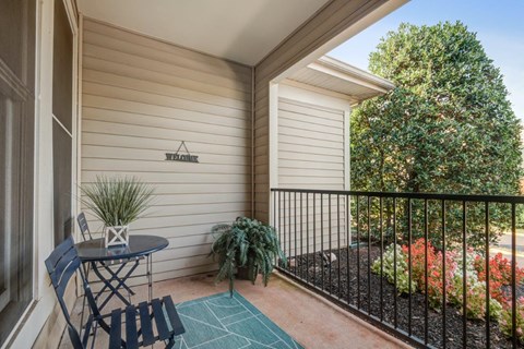 a patio with a table and chairs on a balcony