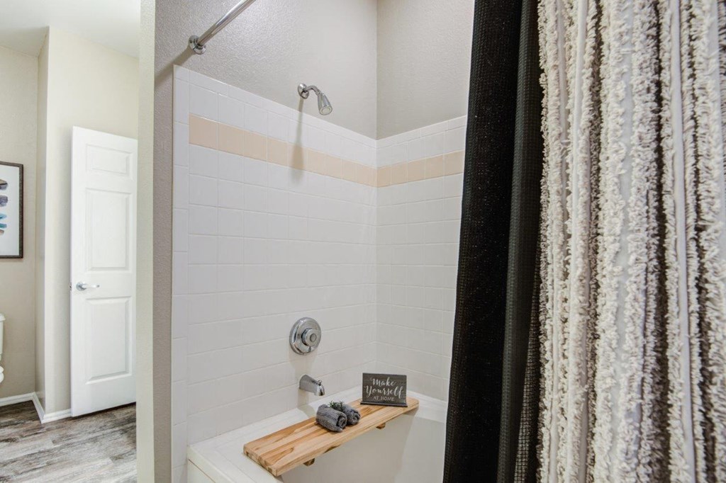 a bathroom with a shower and a curtain