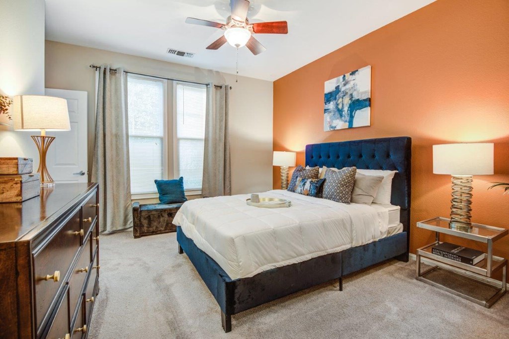 a bedroom with a bed and a ceiling fan