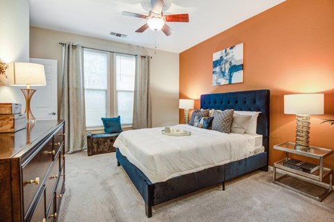 a bedroom with a bed and a ceiling fan