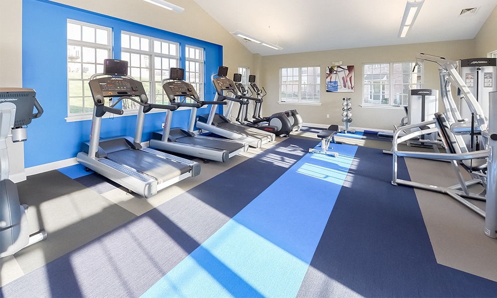 a gym with cardio machines and weights at the at the park apartments