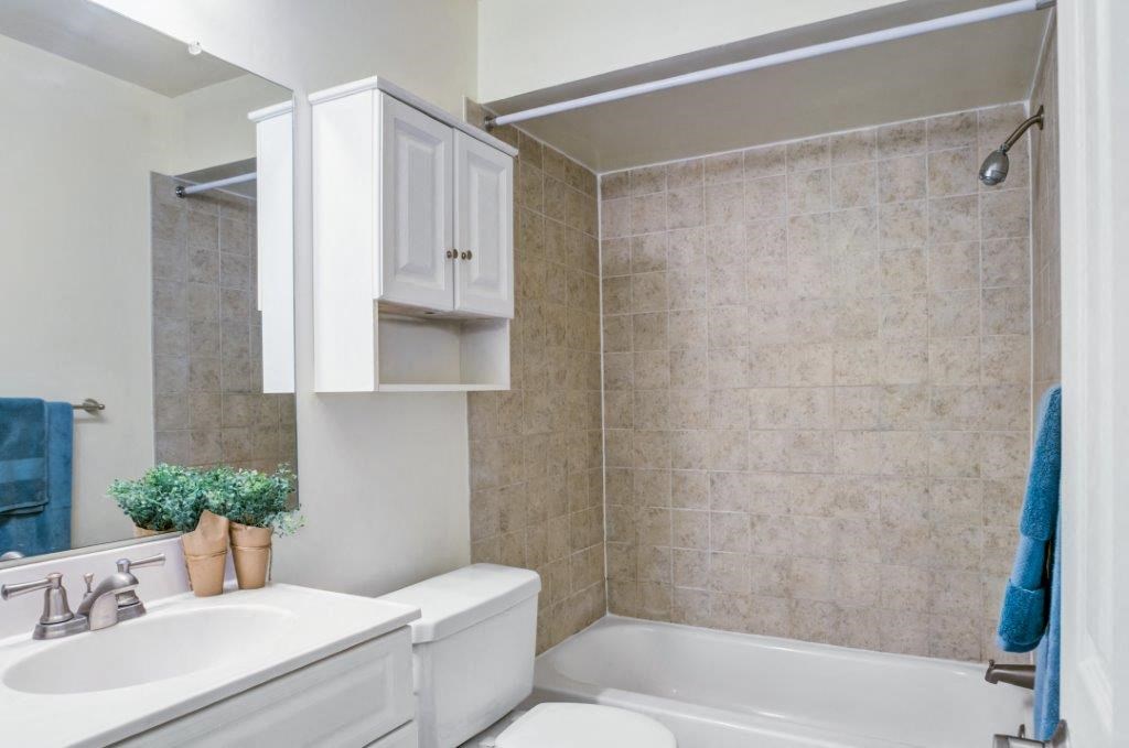 a bathroom with a sink toilet and a bath tub