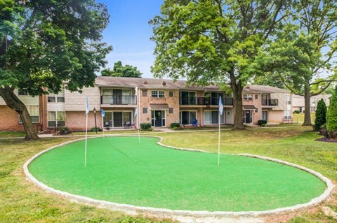 a putting green in front of an apartment building
