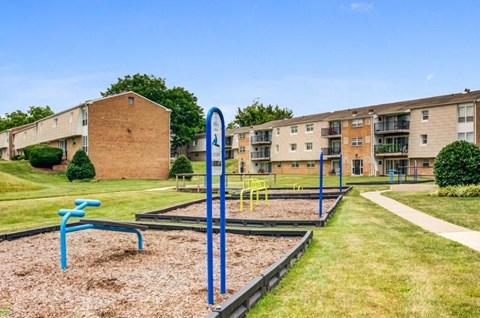 an empty playground in front of an apartment building