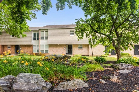 front view of a house with a landscaped yard and rocks