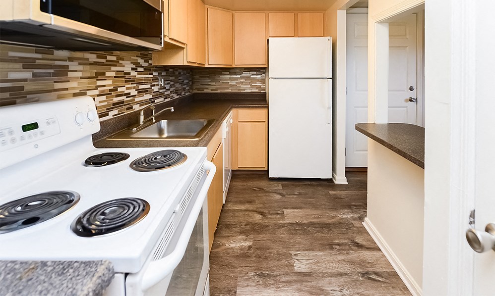 a kitchen with white appliances and a white refrigerator