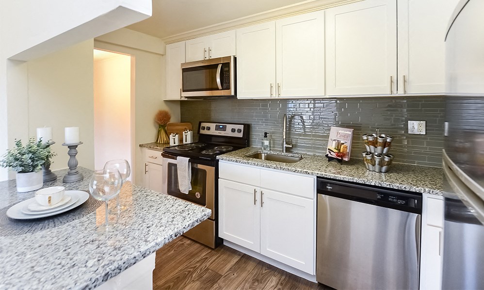 a kitchen with stainless steel appliances and granite counter tops