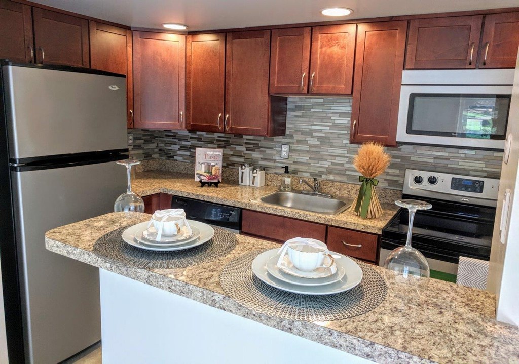 a kitchen with granite counter tops and stainless steel appliances