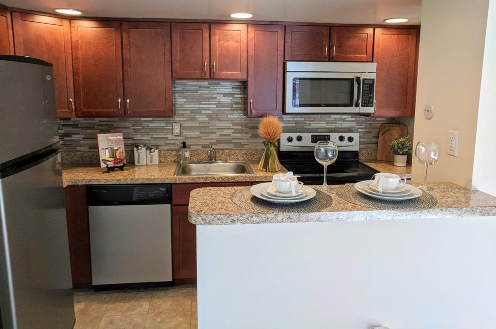 a kitchen with granite counter tops and stainless steel appliances