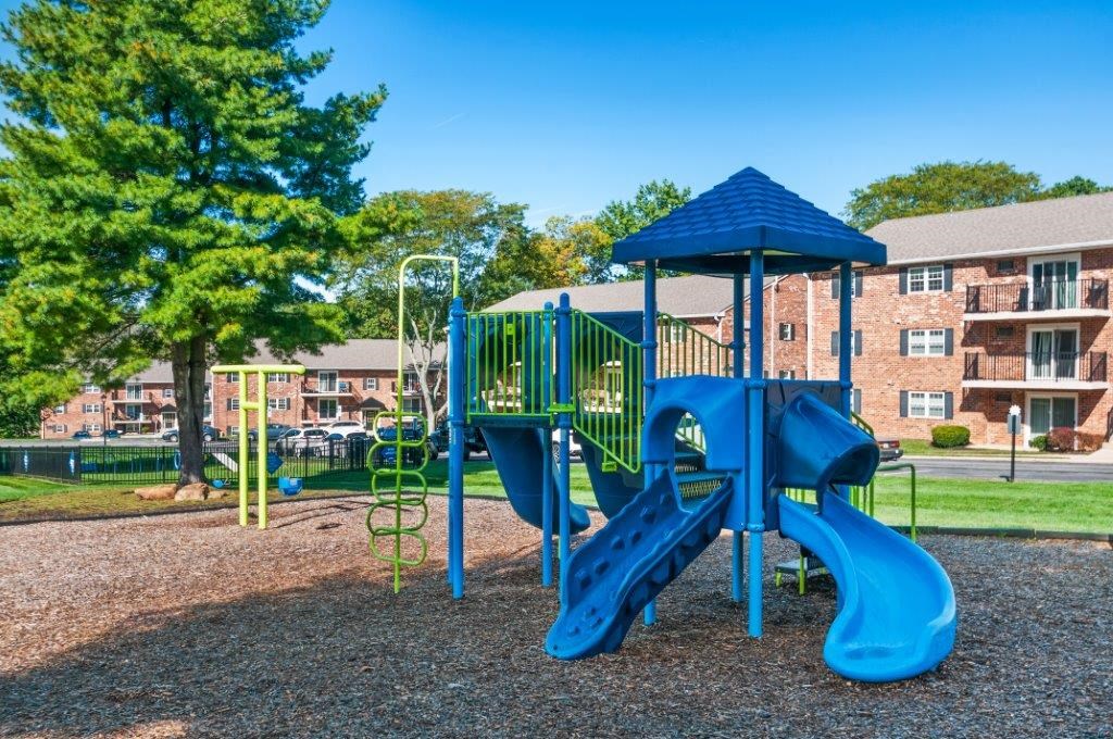 our apartments have a playground with a blue playset